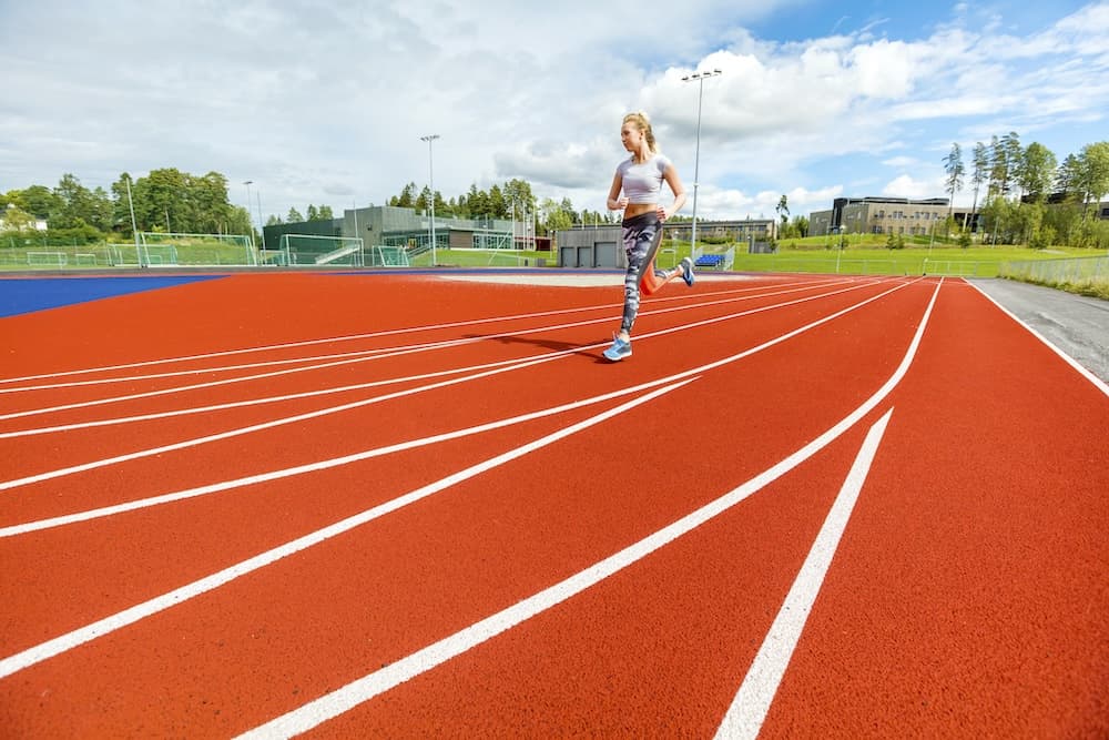 young woman running on sports tracks 2023 11 27 05 10 04 utc